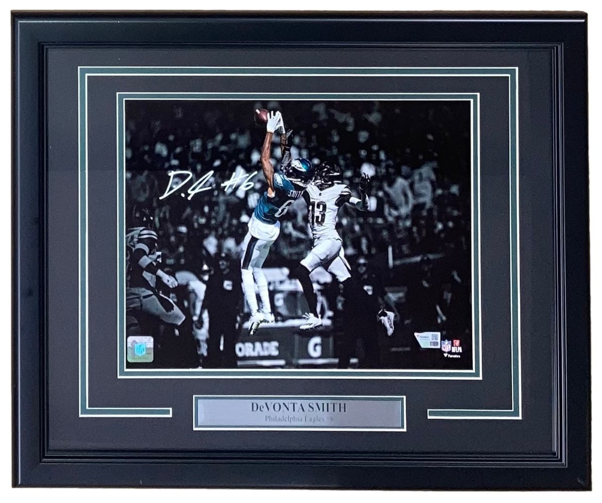 The Sports Integrity Devonta Smith Signed Framed 11x14 Philadelphia Eagles Photo features his autograph and a nameplate, capturing him making a leaping catch. Available from Fanatics.