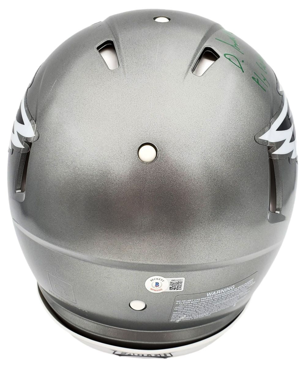 The DeVonta Smith Signed Eagles FS Flash Authentic Speed Helmet by Sports Integrity features a gray design with white wing accents, a green signature on top right, several vents, and a white chin strap.