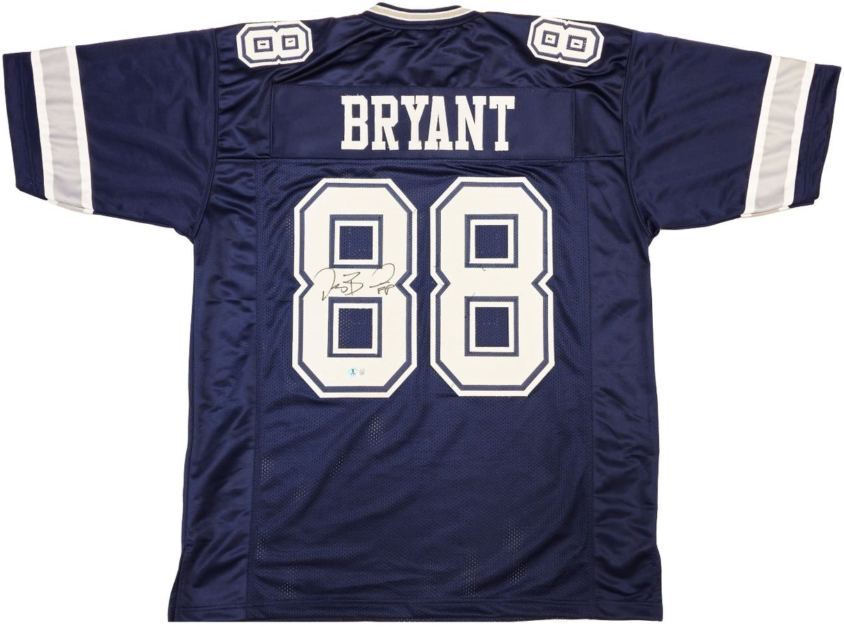 The Sports Integrity Dez Bryant Dallas Signed Navy Blue Football Jersey BAS ITP features white sleeve stripes, "BRYANT" and number 88 on the back, plus Dez Bryant's signature beside the number.