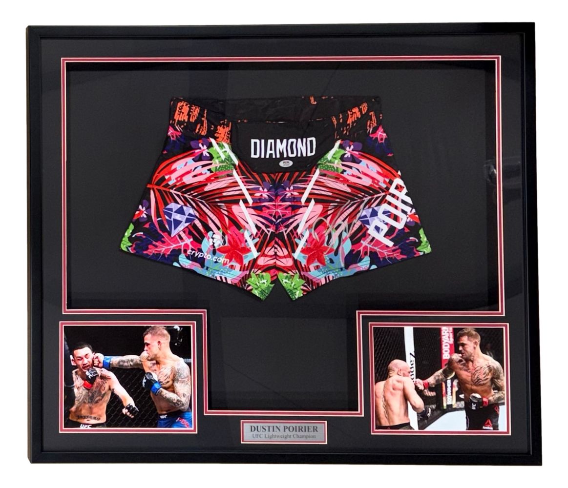 Sports Integrity offers a framed display featuring Dustin Poirier signed custom MMA fight trunks (PSA/DNA), with action photos and a nameplate reading "Dustin Poirier UFC Lightweight.