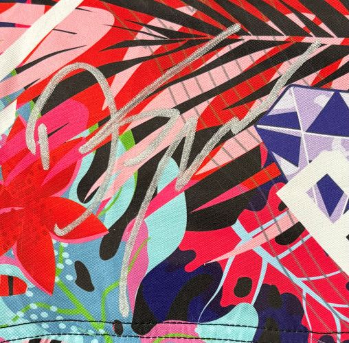 The Dustin Poirier Signed Framed Custom MMA Fight Trunks by Sports Integrity features a colorful abstract design with red flowers, black leaves, blue and purple shapes, plus a bold white signature across the center.