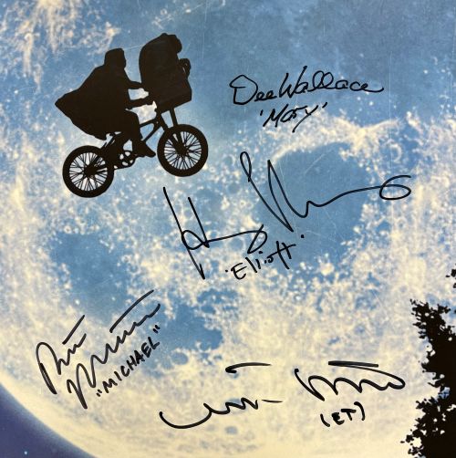 A 24x36 ET poster from Sports Integrity, signed by Henry Thomas, Matthew De Merritt & two others with character names in quotes, features a silhouetted bicycle scene flying across the full moon. JSA authenticated.