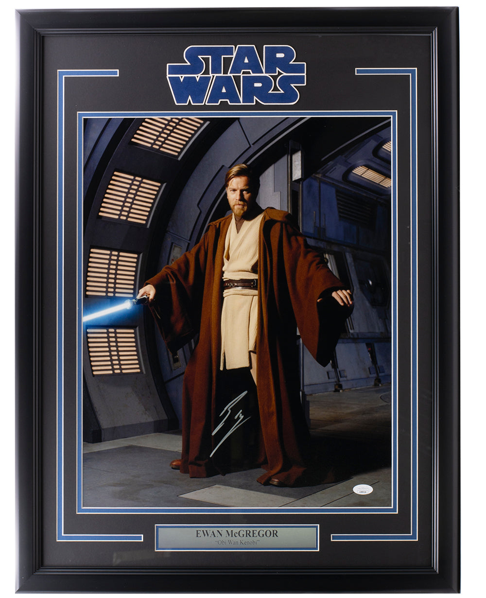 Sports Integrity Ewan McGregor Signed Framed 16x20 Star Wars Obi-Wan Kenobi Pose Photo features a sci-fi setting and blue lightsaber, with a nameplate and JSA authentication.