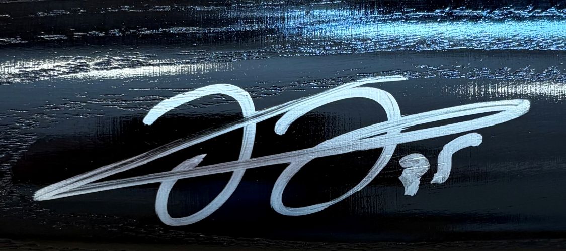 A Frank Thomas Chicago White Sox Signed Black Louisville Slugger Baseball Bat by Sports Integrity features a white autograph with stylized letters and the number 99 on its glossy black surface.