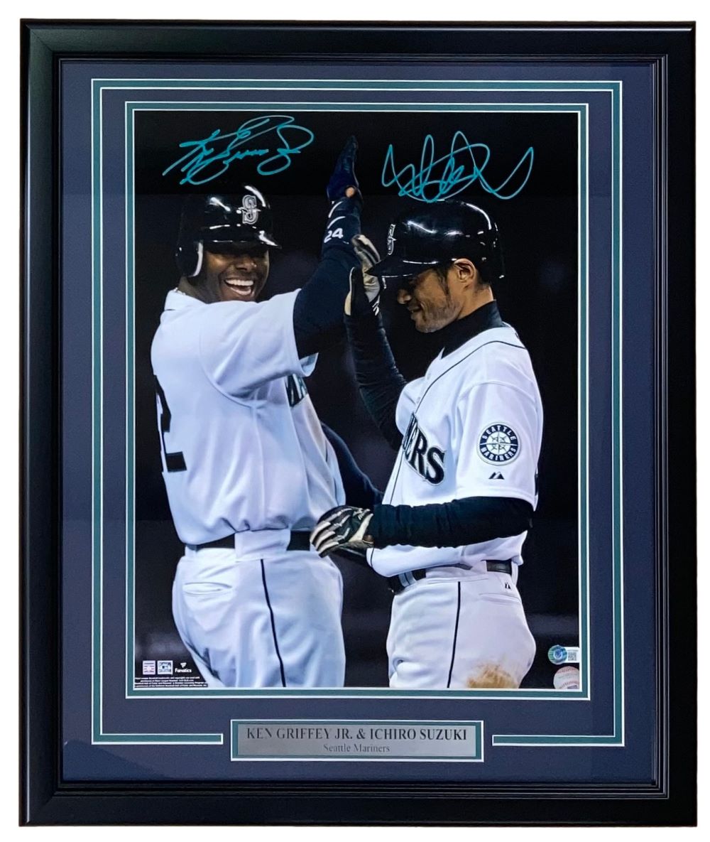 Sports Integrity Ken Griffey Jr. and Ichiro Suzuki Teal Signed Framed 16x20 Seattle Mariners Photo BAS, featuring both autographs, captures the two legends celebrating during a game.