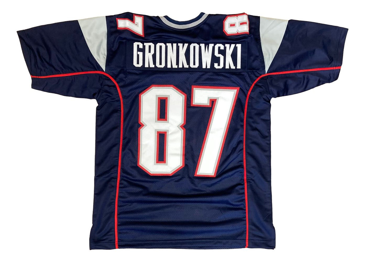 Sports Integrity's Rob Gronkowski New England Blue Football Jersey features white and red trim, with "Gronkowski" and the number 87 in large white print on the back.