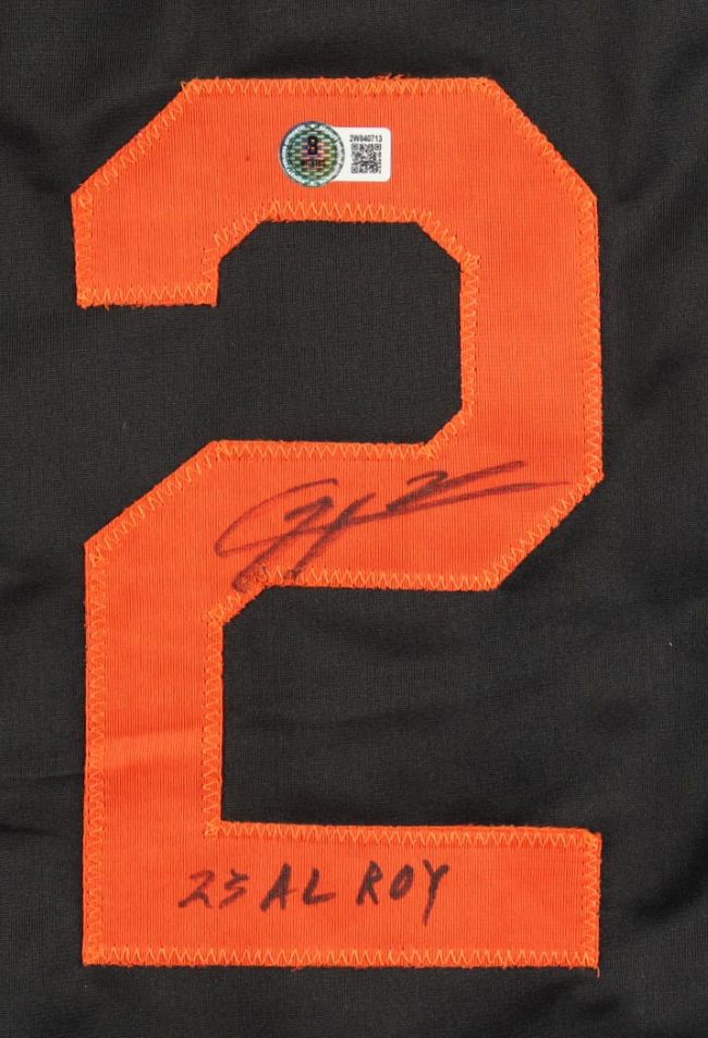 A Gunnar Henderson Baltimore Signed Black Baseball Jersey by Sports Integrity features an orange number 2 patch with his signature and "23 AL ROY" in black marker, plus a certification sticker above.
