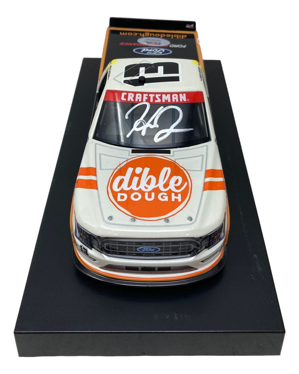 The Sports Integrity Hailie Deegan Signed 1:24 NASCAR Dible Dough Die-Cast Truck features "Craftsman" on the windshield, "Dible Dough" on the hood, a large white autograph, and is displayed on a black base.