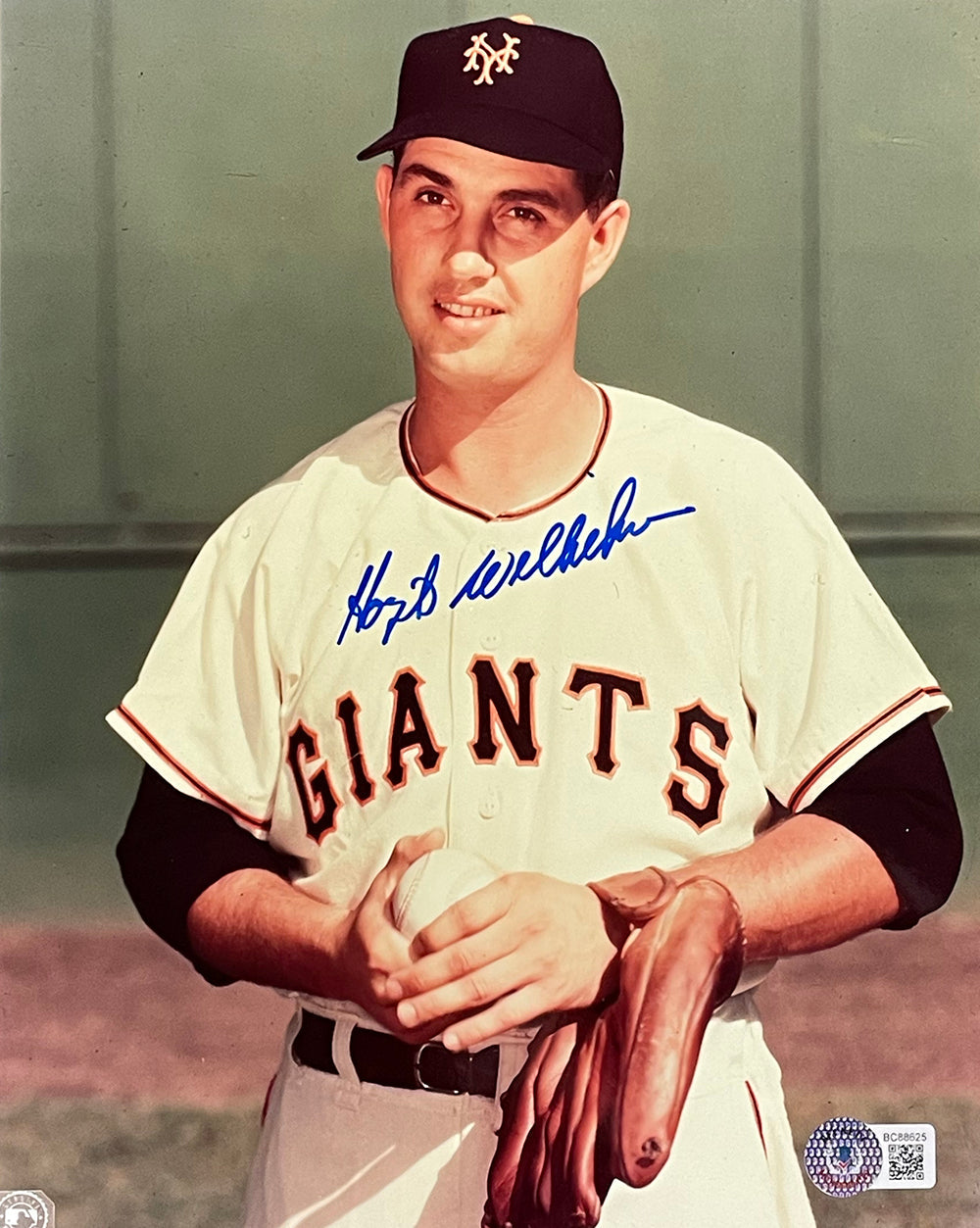 A vintage 8x10 photo of Hoyt Wilhelm in a New York Giants uniform, holding a glove and baseball, with his autograph across the top. Available from Sports Integrity.