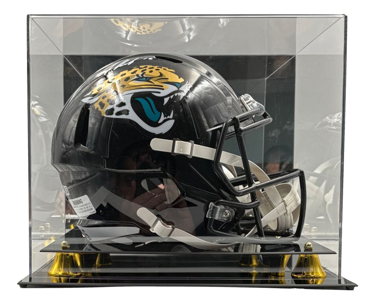 The Travis Hunter Signed Jacksonville Jaguars FS Speed Replica Helmet by Sports Integrity is showcased in a clear acrylic case with a black and gold base.