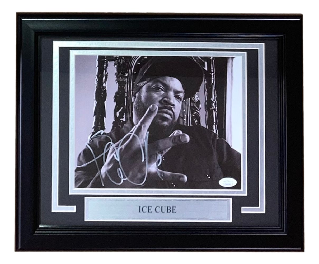 The Sports Integrity Ice Cube Signed Framed 8x10 Photo (JSA) features a black-and-white image of Ice Cube on an ornate chair, hand raised, with a signature and a plaque that reads “ICE CUBE.”.