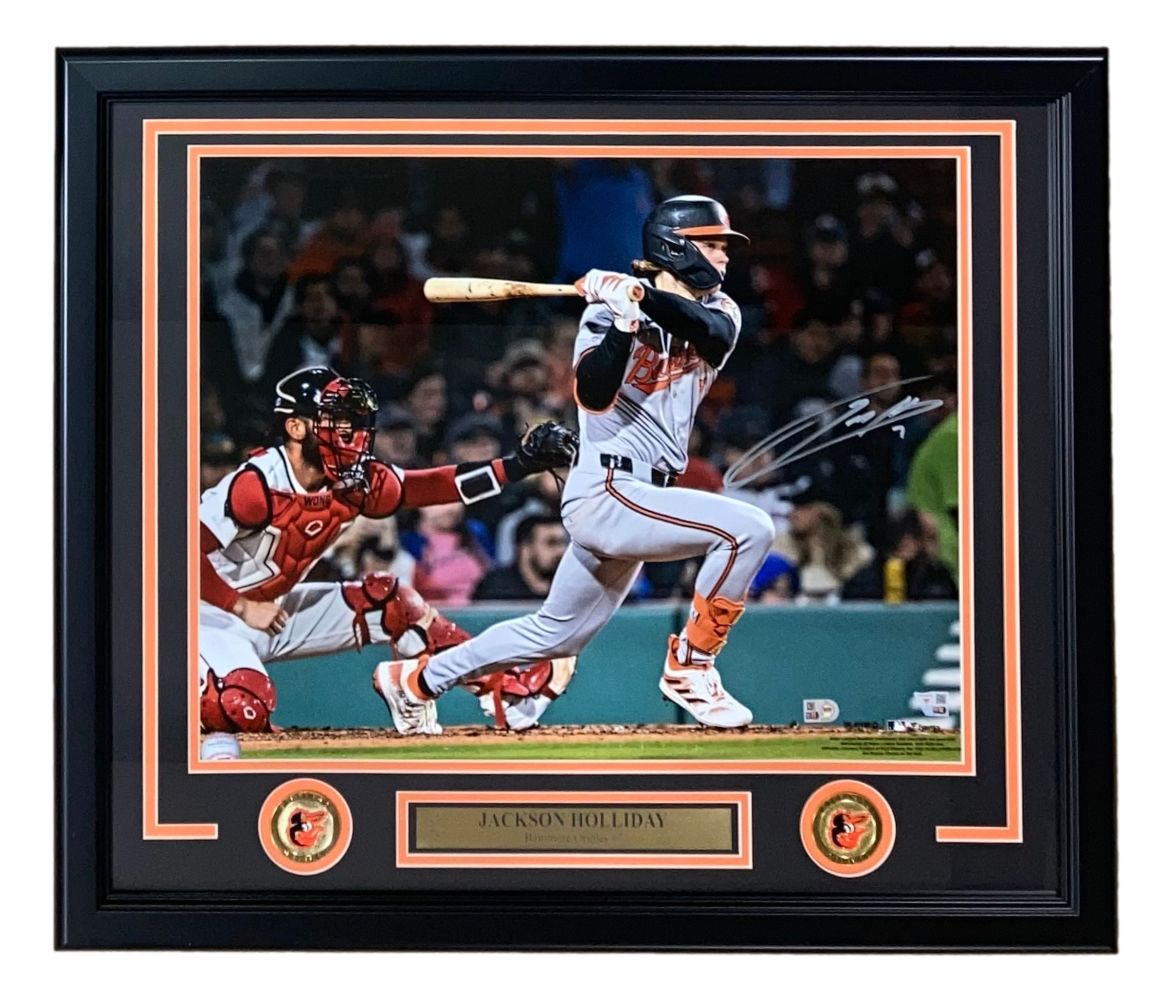 The Sports Integrity Jackson Holliday Signed Framed 16x20 Baltimore Orioles Photo by Fanatics features Holliday batting with a catcher behind him, two Orioles logos, and a nameplate reading "Jackson Holliday.