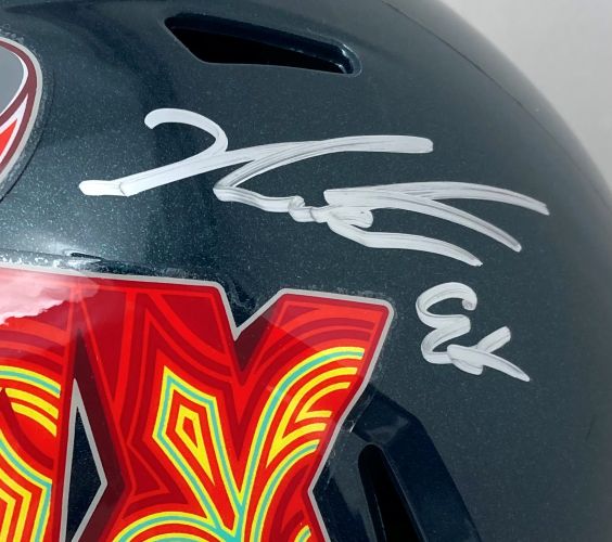 A close-up of a Jalen Carter signed Philadelphia Eagles FS Super Bowl 59 replica helmet by Sports Integrity, featuring a large X decal and an autograph above it.