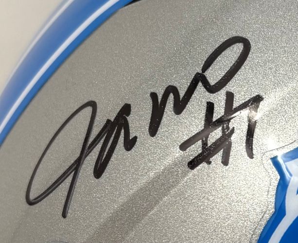 Close-up of a Jameson Williams Signed Detroit Lions Full Size Speed Replica Helmet by Sports Integrity, showing a black autograph and #11 on the silver surface with a blue edge.