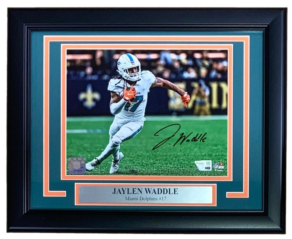 Sports Integrity Jaylen Waddle Signed Framed 8x10 Miami Dolphins Photo features an autographed image of Waddle (#17) in action, with a nameplate displaying his name and team. Authentic Fanatics memorabilia.