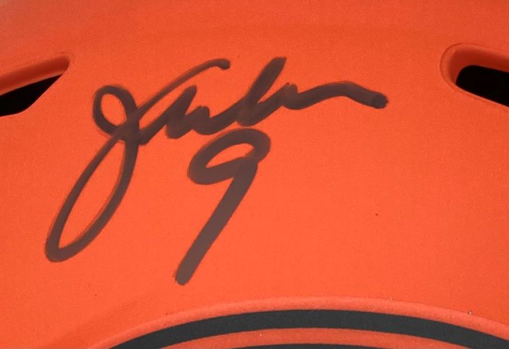 A Jim McMahon autograph with #9 in black on an orange Chicago Bears full-size Rave replica speed helmet by Sports Integrity.