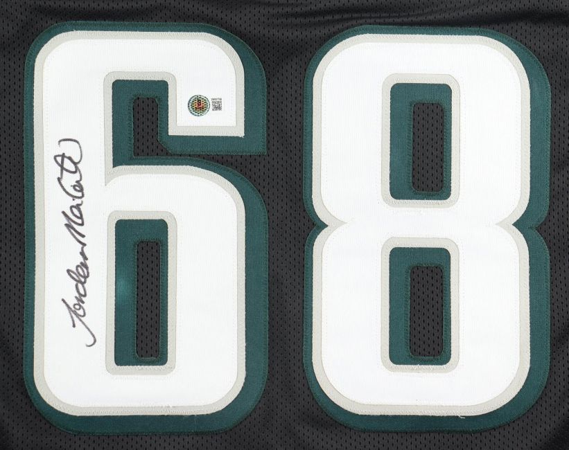 Close-up of a Jordan Mailata Philadelphia Signed Black Football Jersey by Sports Integrity, featuring large white and green number 68 and a signature in black ink on the number 6.