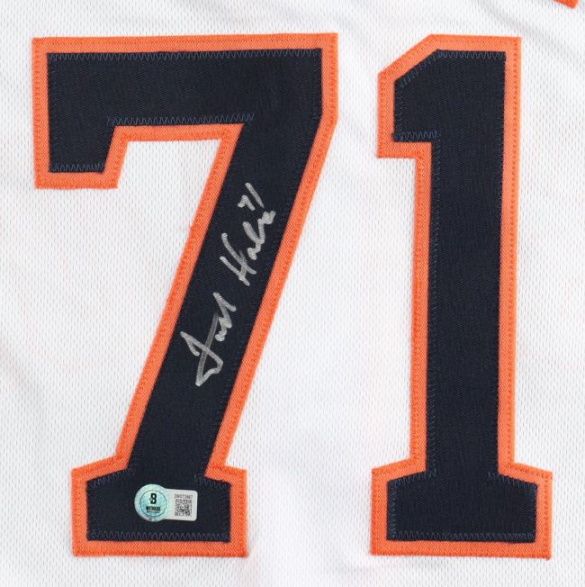 A Sports Integrity Josh Hader Houston Signed White Baseball Jersey features large navy blue and orange number 71, a silver autograph across the 7, and a BAS authentication sticker at the bottom of the 7.