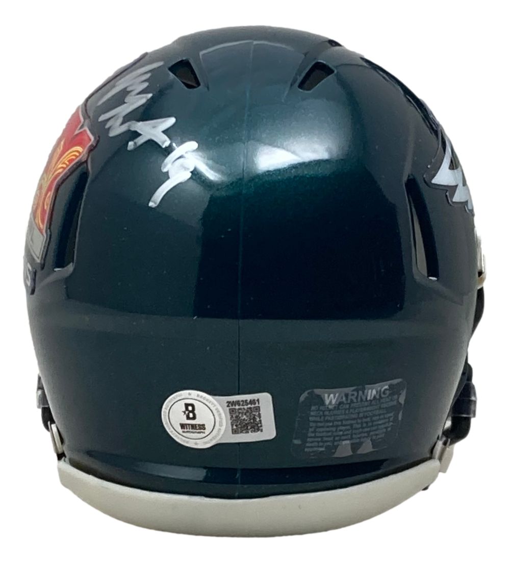 A Josh Sweat signed Philadelphia Eagles Super Bowl 59 LIX Mini Speed Helmet by Sports Integrity features a dark green finish, silver autograph, certification stickers, warning label, and part of the red and yellow logo on the side.