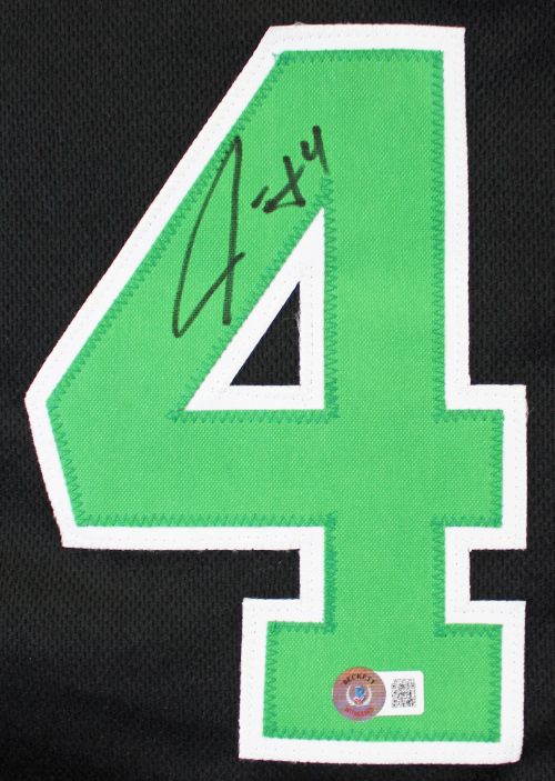 A Jrue Holiday Boston signed black basketball jersey by Sports Integrity features a large green number 4 with a white outline, Jrue's black marker signature, and a BAS authentication sticker at the bottom.