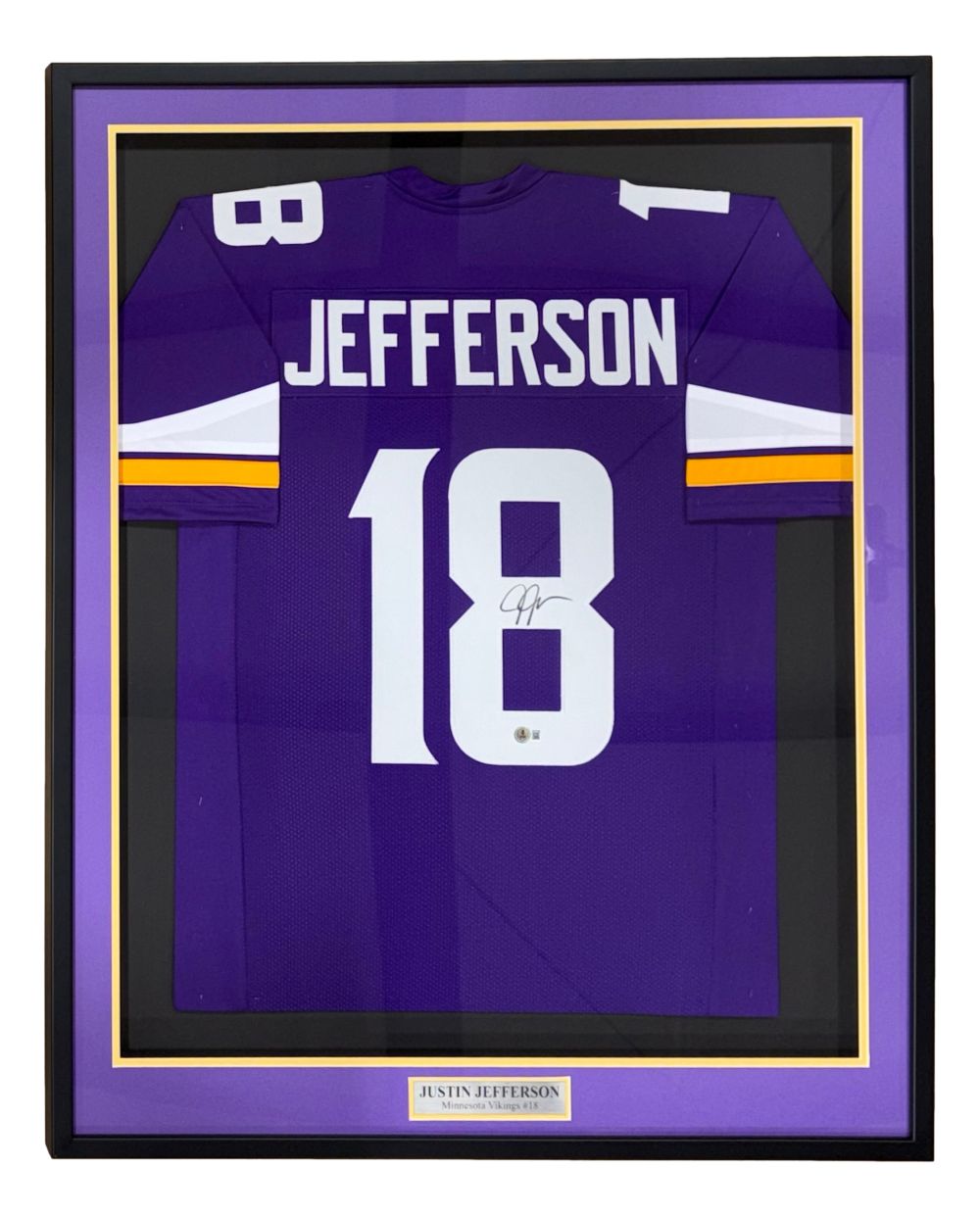 The Sports Integrity Justin Jefferson Minnesota Signed Framed Purple Football Jersey BAS features a purple jersey with "JEFFERSON" and number 18, autographed, matted in gold and purple, and displayed behind glass.