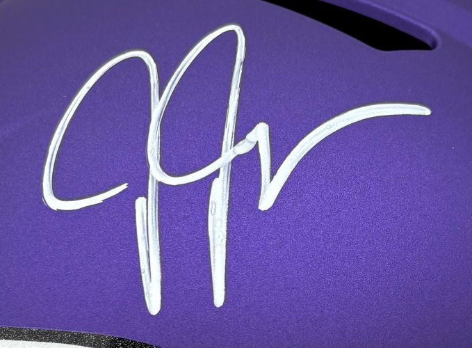 A large, stylized white autograph in marker is featured on a purple Justin Jefferson Signed Minnesota Vikings Full Size Replica Speed Helmet by Sports Integrity.