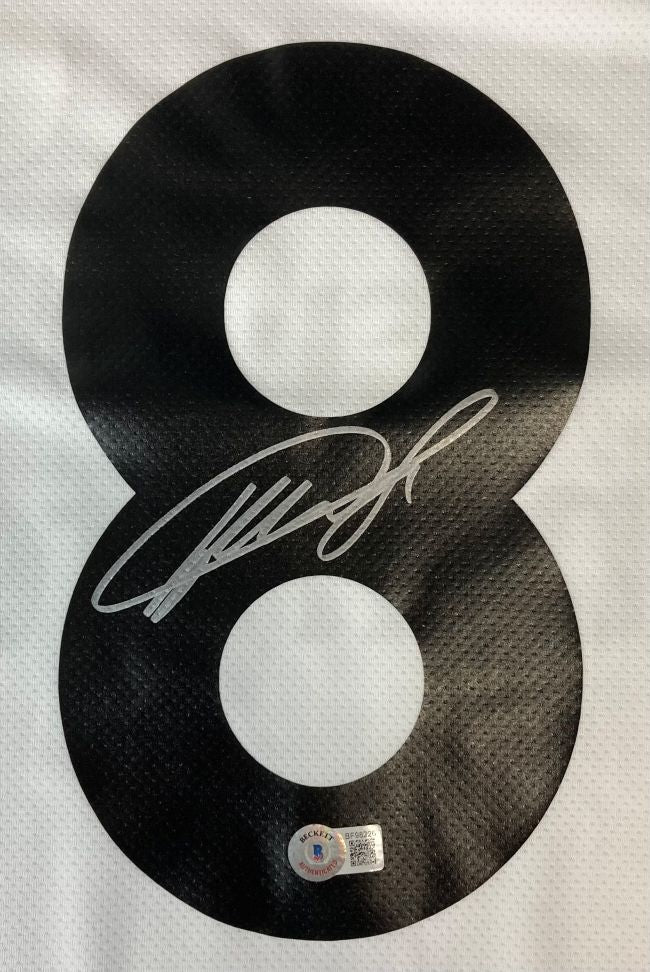 A Kaka Signed Real Madrid White Adidas Soccer Jersey by Sports Integrity features a large black number 8 printed on white mesh, autographed in silver ink with a BAS authentication sticker below the signature.