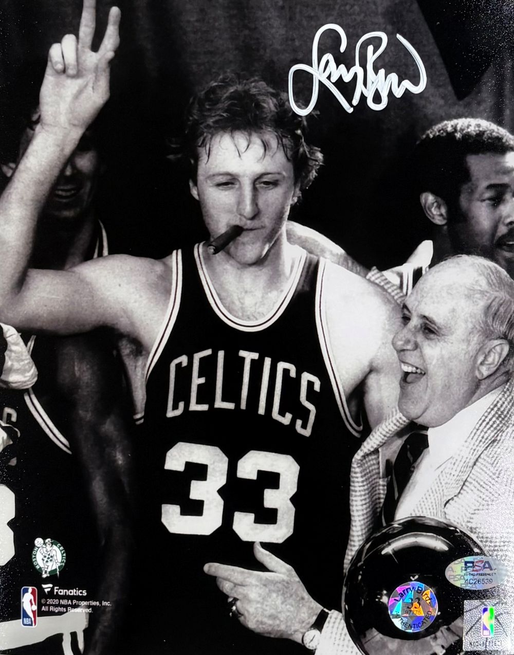 Larry Bird, in a Celtics #33 jersey, celebrates with Red Auerbach in this black and white 8x10 photo. Both are smiling; Bird holds up two fingers and smokes a cigar. Birds autograph is at the top. Product by Sports Integrity, PSA/DNA certified.