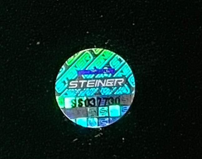 A Sports Integrity holographic sticker appears on the Larry Johnson Signed 16x20 UNLV Runnin Rebels Story Inscribed Photo, featuring "STEINER" in bold, a visible serial number below, and metallic reflective colors set against a black background.
