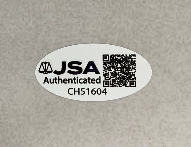 A Sports Integrity Lawrence Taylor Signed 16x20 New York Giants Cunningham Sack JSA QR comes with an oval sticker displaying "JSA Authenticated CH51604" and a QR code on a plain, light-colored surface.