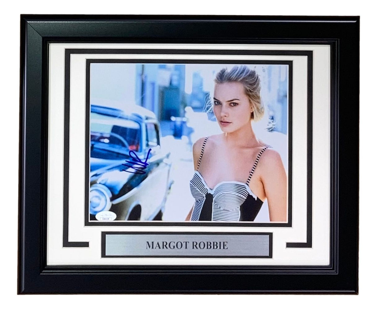 Margot Robbie Signed Framed 8x10 Photo by Sports Integrity features her in a black and white dress by a vintage car, complete with autograph and nameplate.