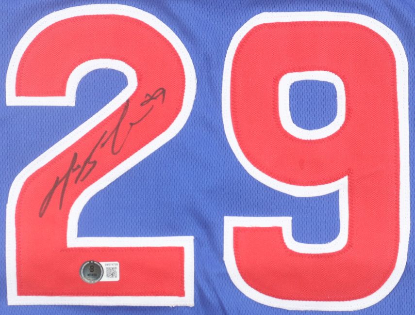 A close-up of the Sports Integrity Michael Busch Chicago Signed Blue Baseball Jersey BAS shows a bold red-and-white number 29 with a black autograph on the left side of the 2 and an authentication sticker underneath.