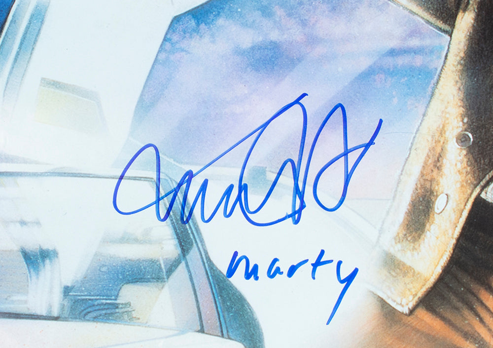 This Sports Integrity Michael J. Fox Signed Framed Back To The Future 3 32x46 Movie Poster features a blue autograph with "marty" inscribed, plus part of a white car and brown jacket—essential memorabilia for any fan.
