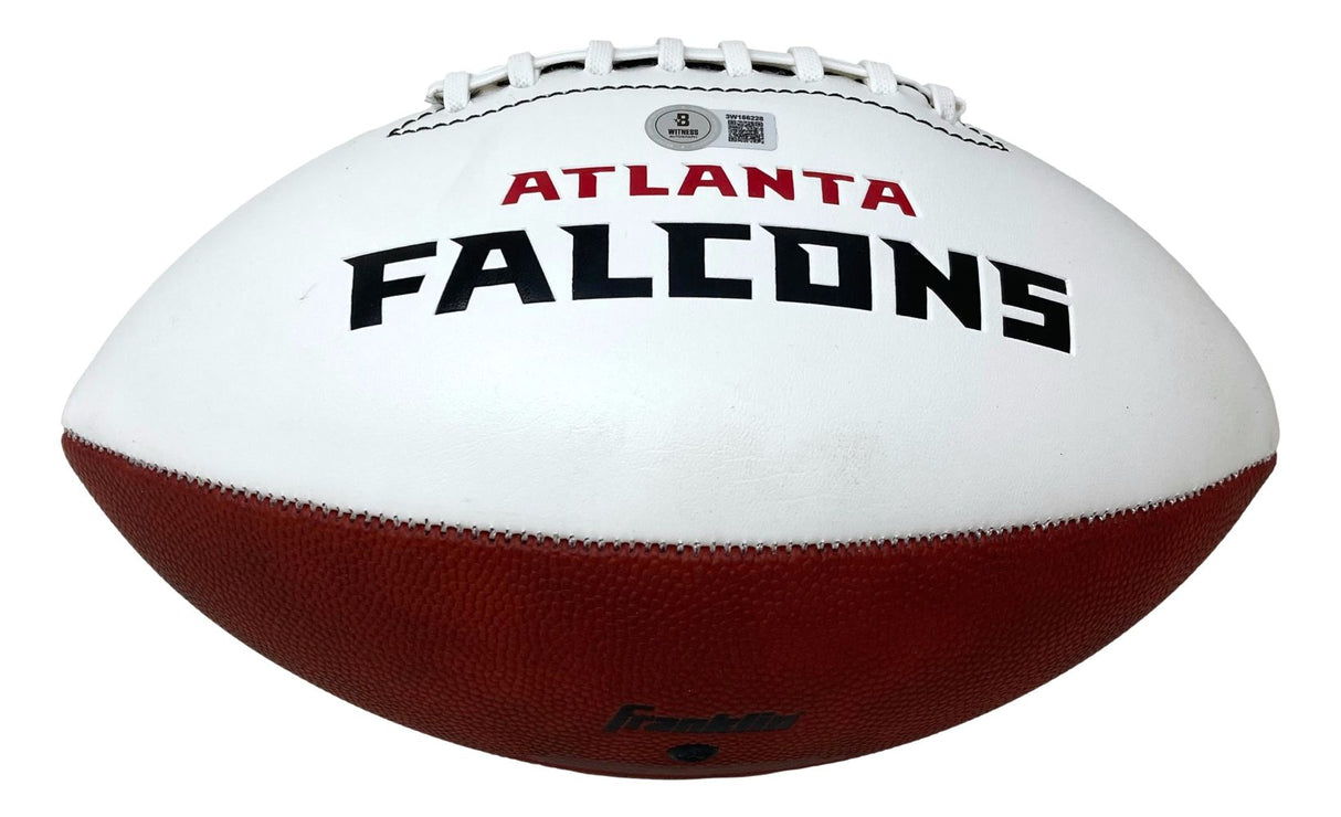 A white and brown football by Sports Integrity, featuring ATLANTA FALCONS in black and red on the white panel, signed by Michael Vick and representing the Atlanta Falcons NFL team.