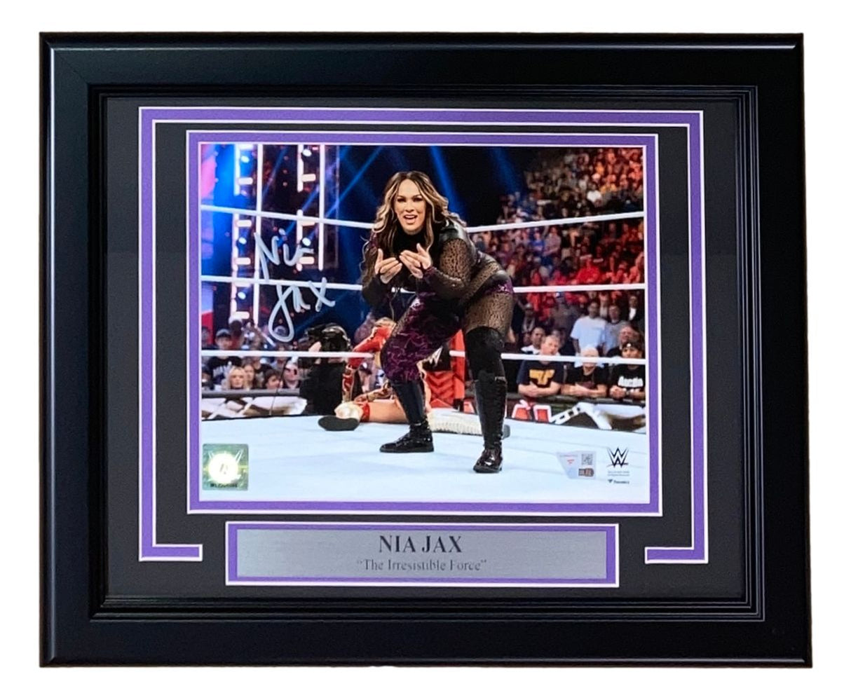 The Sports Integrity Nia Jax Signed Framed 8x10 WWE Photo from Fanatics features her autograph, an action ring pose, cheering fans in the background, and a name/title plaque reading "The Irresistible Force.