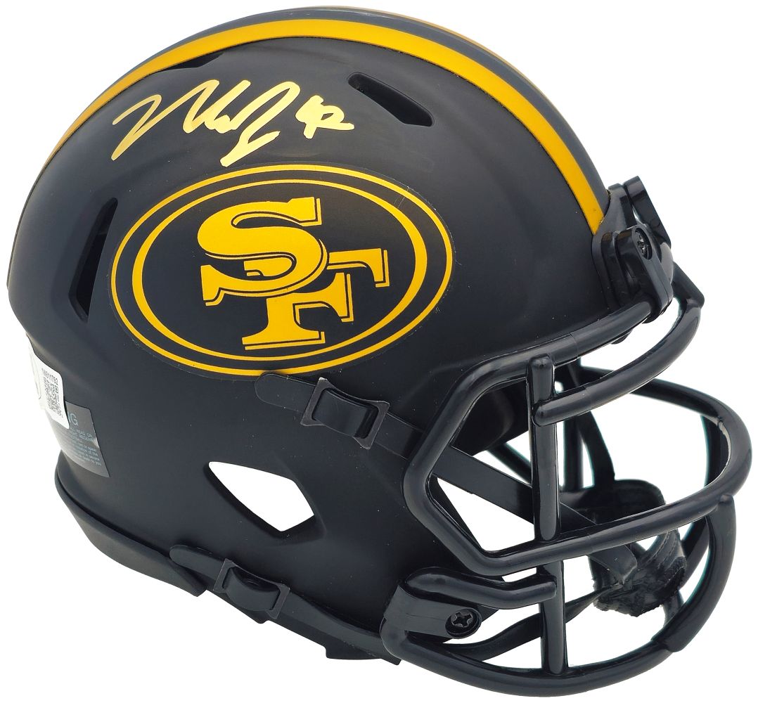 The Sports Integrity Nick Bosa Signed San Francisco 49ers Eclipse Mini Speed Helmet features a matte black finish with yellow accents, the SF logo, and Nick Bosa’s yellow signature on top.