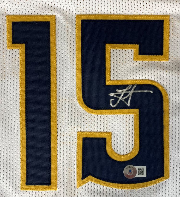 The Sports Integrity Nikola Jokic Denver Signed White Basketball Jersey BAS features a white mesh design with navy blue and gold number 15, a signature on the 5, and an authenticity sticker with QR code below it.