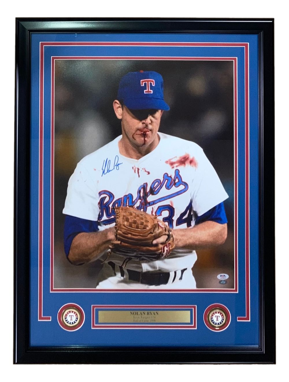 Sports Integrity's Nolan Ryan Signed Framed 16x20 Texas Rangers Bloody Lip Photo (PSA/DNA) features the legendary pitcher in a white uniform and blue cap, holding a glove, with his autograph and team logos included.