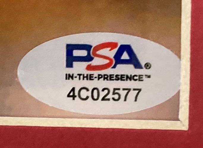 Close-up of the PSA oval sticker on the Nolan Ryan Signed Framed 8x10 Texas Rangers Bloody Lip Photo by Sports Integrity, featuring the IN-THE-PRESENCE™ text and ID number 4C02577 in black on a white background.