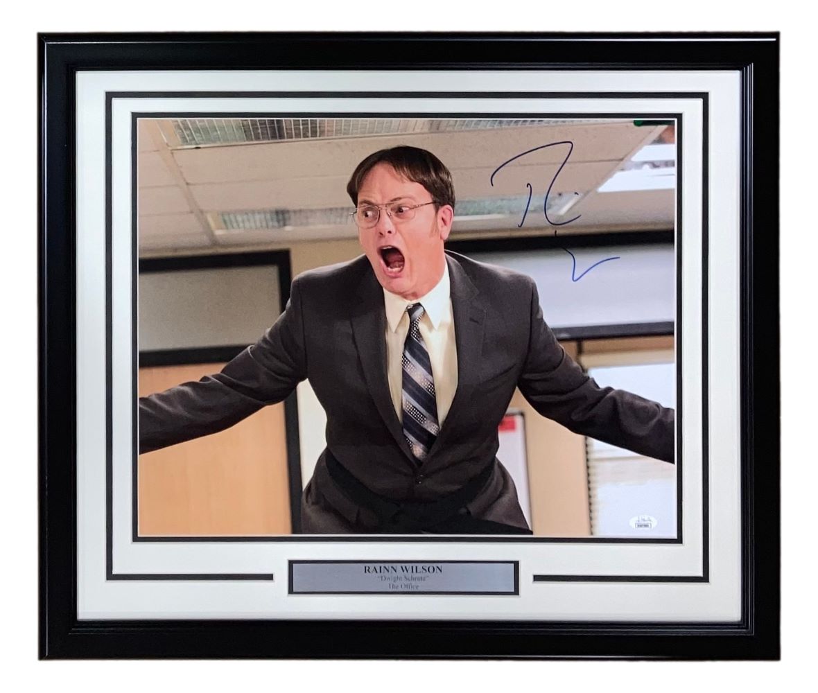 The Sports Integrity Rainn Wilson Signed Framed 16x20 Photo features Dwight Schrute as manager in The Office, suited and yelling with arms outstretched. Includes a plaque and JSA authentication, matted with a black border.