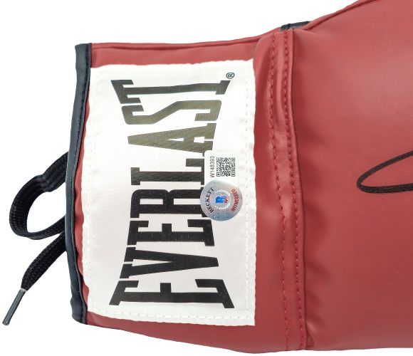 A close-up of a Sugar Ray Leonard signed red Everlast right hand boxing glove by Sports Integrity, featuring a white patch with the black Everlast logo and a BAS authentication sticker near the center.