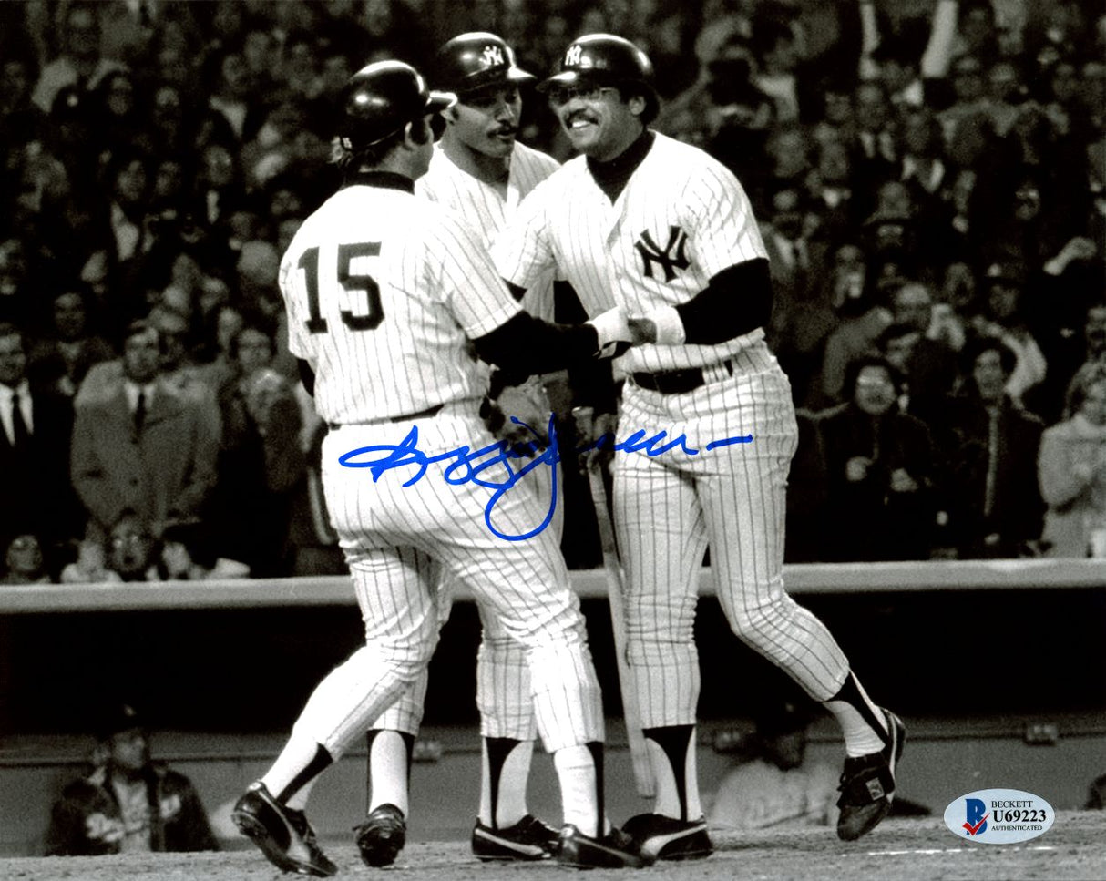 Three New York Yankees in pinstripes celebrate on the field in this Sports Integrity Reggie Jackson Signed B&W 8x10 Photo (BAS), with a blue autograph visible and cheering fans in the background.