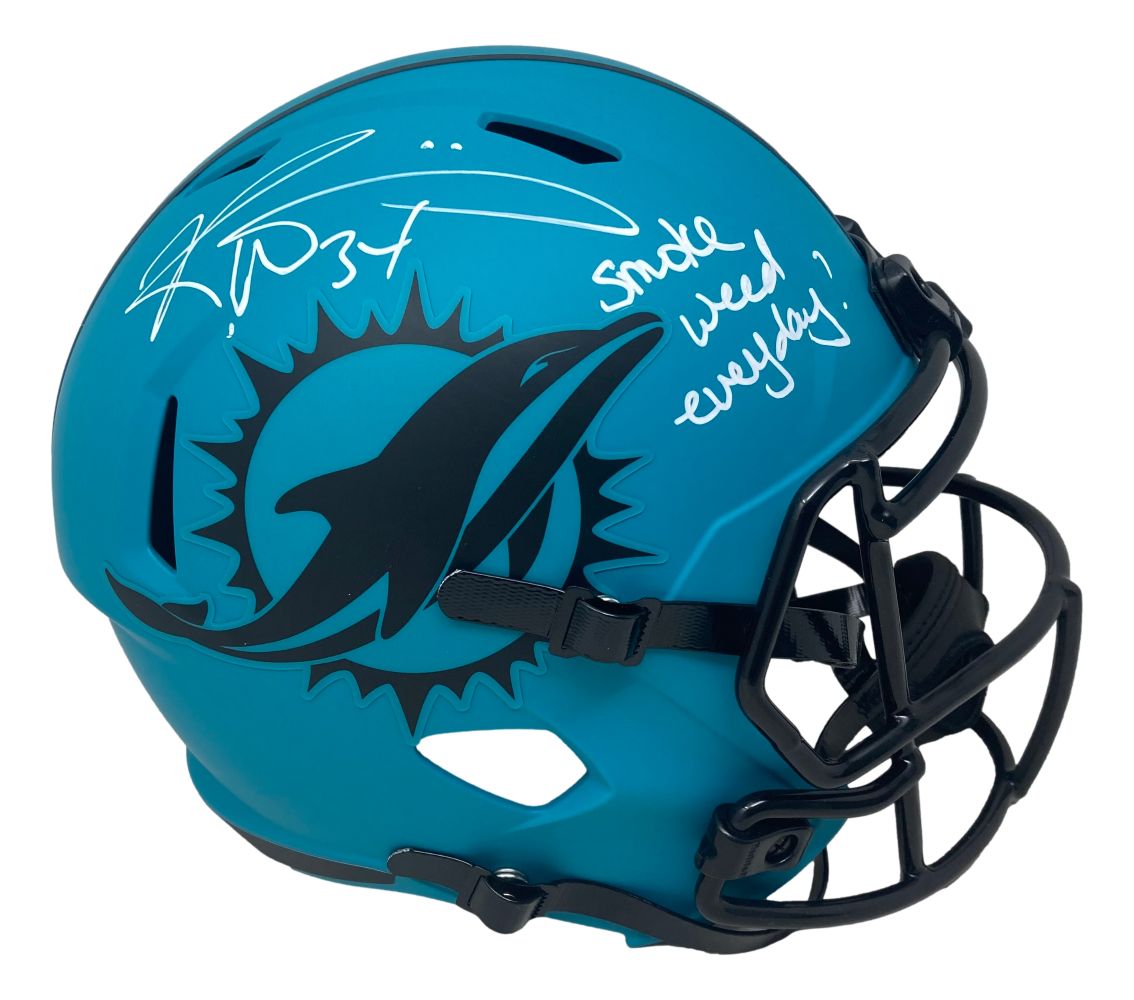 The Sports Integrity Ricky Williams Signed Dolphins FS Rave Speed Replica Helmet features a teal design with a black dolphin logo and faceguard, plus a white autograph reading "Smoke Everyday.
