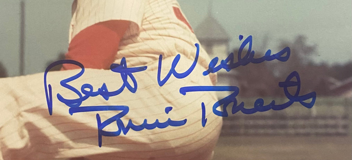 A close-up 8x10 photo of Philadelphia Phillies pitcher Robin Roberts in a striped uniform, signed with “Best Wishes” and authenticated by JSA (AL44179), offered by Sports Integrity; fence and buildings appear in the background.
