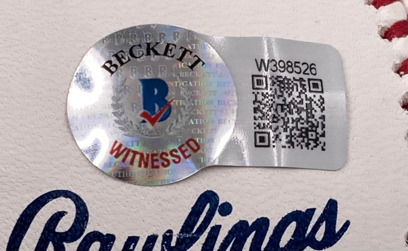 Close-up of a Beckett Witnessed holographic sticker with a QR code and serial number on a Scott Rolen Cardinals Signed Official Hall Of Fame Logo Baseball w/ Case by Sports Integrity. The sticker features the Beckett logo and "WITNESSED" in red.