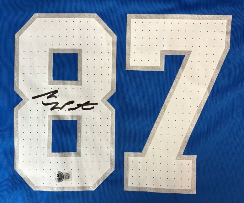 The Sports Integrity Sam LaPorta Signed Detroit Lions Blue Nike Game Replica Jersey features large white numbers 87 with gray outlines and a black autograph across the upper left of the number 8.