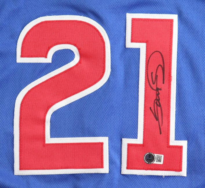 The Sports Integrity Sammy Sosa Chicago Signed Blue Baseball Jersey BAS features large red and white number 21, with a black signature and a small authentication sticker with QR code near the bottom of the 1.