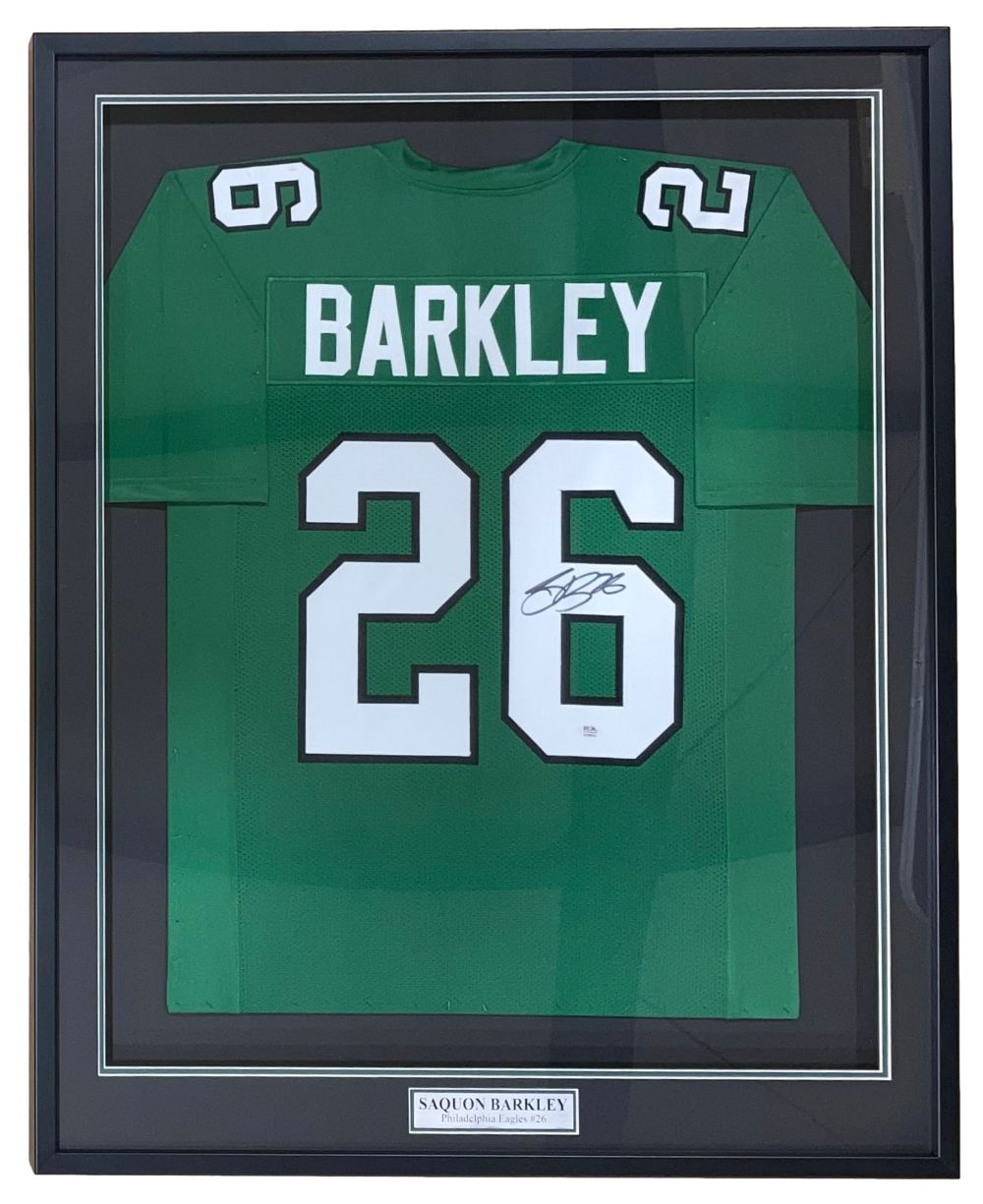 Sports Integrity's Saquon Barkley Philadelphia Signed Framed Kelly Green Football Jersey (PSA/DNA) features "Barkley" and number 26, with autograph on the number and a plaque reading Saquon Barkley.