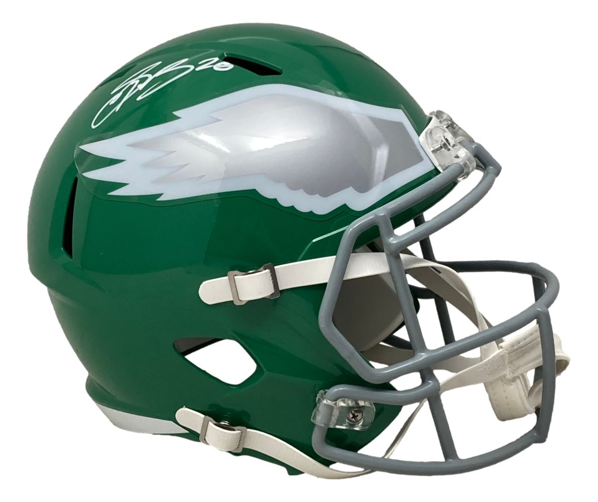 The Sports Integrity Saquon Barkley Signed Eagles FS Kelly Green Replica Speed Helmet (PSA/DNA) features a green helmet with white/silver wing design, gray facemask, white chin strap, and Saquon's signature in white ink.