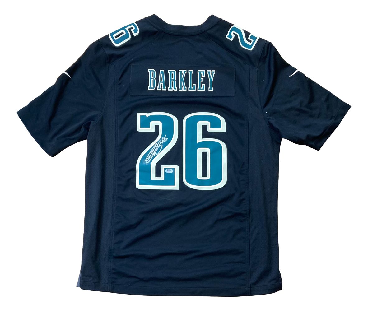 A black Nike Super Bowl 59 Eagles jersey by Sports Integrity, featuring BARKLEY and number 26 in white and light blue with Saquon Barkley's signature. PSA authenticated, item 3C89561; number 26 also on shoulders.